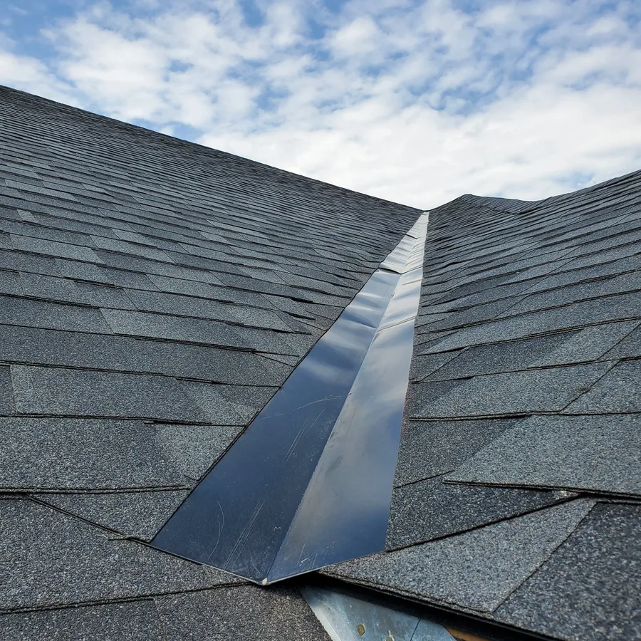 Metal valley flashing between two shingled roof planes