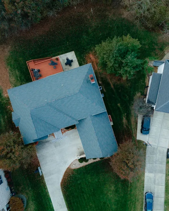 Overhead drone view of suburban house roofs