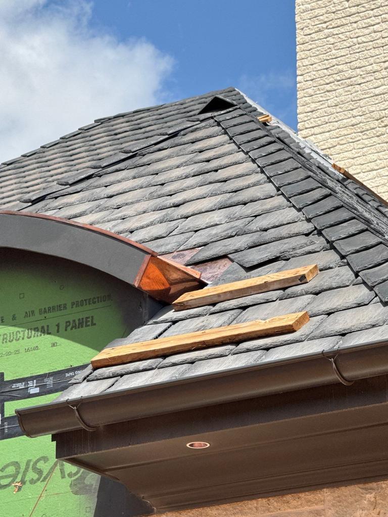 Copper ridge and valley flashing at an arched dormer on a home in Oklahoma City