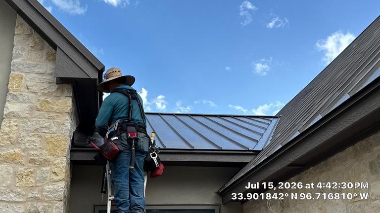 Black metal roof installation on a stone home in Kingston, Oklahoma