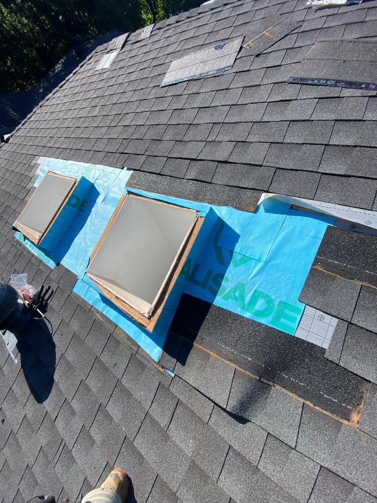 Close-up of skylight flashing repair and new underlayment on a roof in Edmond, Oklahoma