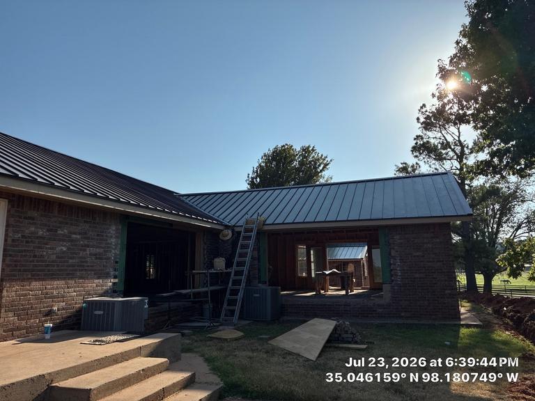 Standing seam metal roof in golden-hour light in Anadarko, Oklahoma